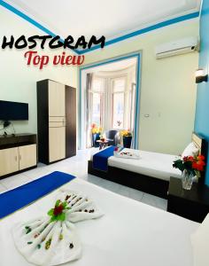 A bed or beds in a room at Hostgram Top View