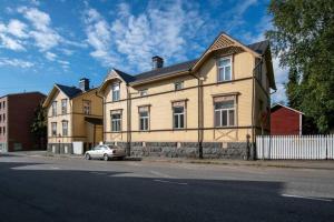 a house with a car parked in front of it at Historic SELF-SERVICE apartment in downtown Vaasa in Vaasa