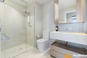 a bathroom with a toilet and a sink and a shower at Elevated Luxury at QWR City & River Views in Brisbane