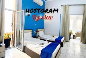 A bed or beds in a room at Hostgram Top View