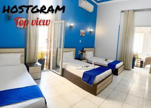 A bed or beds in a room at Hostgram Top View