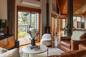 a living room with a couch and a table at Gold Coast Mountain Retreat in Mount Tamborine