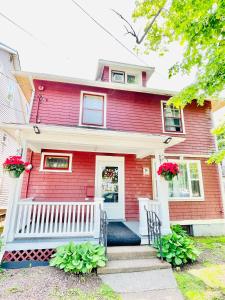 a red brick house with a white porch at Prime and Precious location The Red House Room3 in Charlottetown