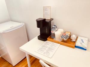 a coffee maker on a table next to a refrigerator at Prime and Precious location The Red House Room3 in Charlottetown