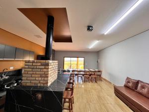 a living room with a fireplace and some chairs at Casa de campo da Vo Cecilia em Dona Ines PB in Dona Inês