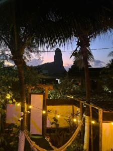 a view of a mountain at night with palm trees at Casa de Mirtes in Fernando de Noronha +39 photos