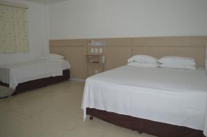 Postel nebo postele na pokoji v ubytování Richard Hotel