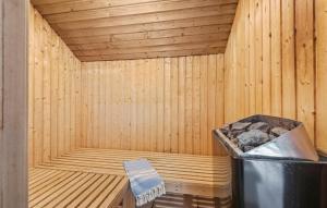 a wooden sauna with a trash can in it at 4 Bedroom Pet Friendly Home In Blåvand in Ho +20 photos