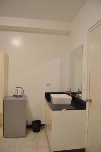 a bathroom with a sink and a mirror at Good Shepherd Apartelle in Urdaneta