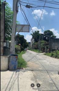 an empty street with a sign on a pole at Good Shepherd Apartelle in Urdaneta