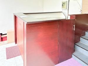 an open door in a room with stairs at RedDoorz Syariah at Nusa Indah near BNS in Batu