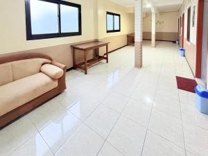 a living room with a couch and a table at RedDoorz Syariah at Nusa Indah near BNS in Batu +38 photos