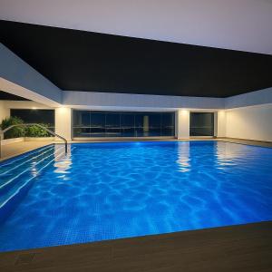 una grande piscina blu in un edificio di Dep Titanium 3hab Squash Piscina Gym Cine Ofi-Room a Daule