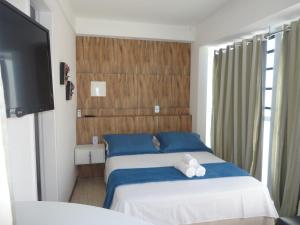 Tempat tidur dalam kamar di Pousada Pedacinho da Bahia