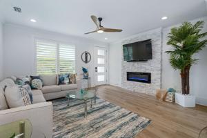 a living room with a couch and a fireplace at Tipsy Turtle l Heated Pool l Walk to Beach in Saint Augustine