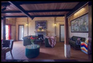 a living room with couches and a fireplace at Minh Sapa Mountain House in Sa Pa
