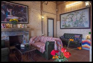 a living room with a couch and a fireplace at Minh Sapa Mountain House in Sa Pa