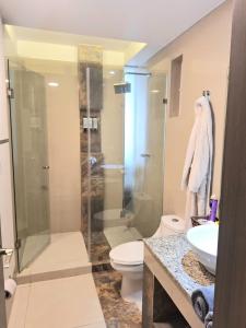 a bathroom with a shower and a toilet and a sink at Condo Azul in Cancún