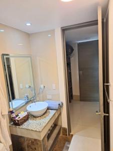 a bathroom with a sink and a mirror at Condo Azul in Cancún +4 photos