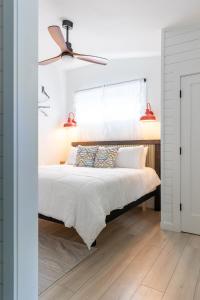 a bedroom with a bed and a ceiling fan at Tranquility Pond Cottage, Relax, Fish and Unwind in Buford