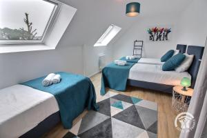 a bedroom with two beds and a window at Ormeau in Erquy +23 photos