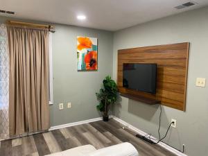 a living room with a flat screen tv on a wall at The Big Beautiful Townhouse in Frederick