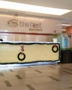 a store with a sign that reads the next supreme informant at Cozy 1BR Apartment with Home Office at The Nest Jakarta Barat in Jakarta +17 photos