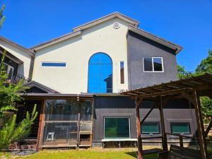 a house with a blue window on the side of it at Poam Mountain Pool Villa Pension in Mungyeong