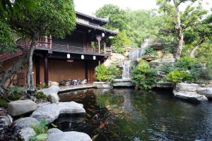 a koi pond in front of a building at Phuong Nam Resort in Thuan An