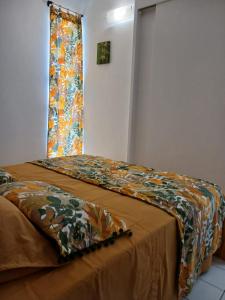 Cama en habitación con ventana y cortina en Appartement MANBANNA 324, en Grand-Bourg 8 fotos más
