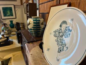 a plate with a picture of a girl on it at はたご屋ちゅうべ in Taki