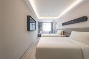 Voodi või voodid majutusasutuse Atour Light Hotel Beijing Guang'anmen toas