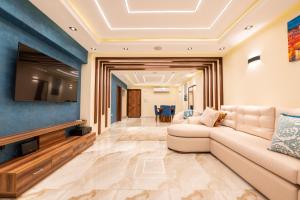 a living room with a couch and a tv at Royal Heliopolis in Cairo