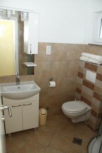 a bathroom with a sink and a toilet at Apartments Jadera in Privlaka