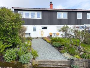 a house with a garden in front of it at Central Trshavn Apartment in Tórshavn