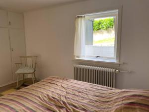 a bedroom with a bed and a window at Central Trshavn Apartment in Tórshavn