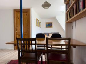 a dining room with a wooden table and chairs at Central Trshavn Apartment in Tórshavn
