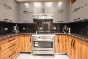 a kitchen with wooden cabinets and a stainless steel oven at Royal Heliopolis in Cairo