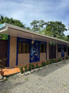 a building with blue and white paint on it at Cabinas Caribe Azul in Cocles