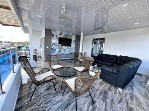 a living room with a couch and a table and chairs at Hotel Costa Norte in Necoclí