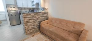 a living room with a couch in a kitchen at Holiday Apartment 3 in Jijel