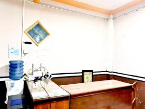 a kitchen with a table and a counter top at RedDoorz at Hotel Huni Raya Bromo in Pasuruan +31 photos