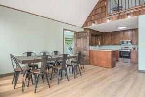 a kitchen and dining room with a table and chairs at Relaxing River Cabin! 