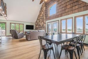 a dining room with a table and chairs at Relaxing River Cabin! 