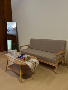 a couch and a coffee table in a room at Manson Goat Cottage in Cameron Highlands