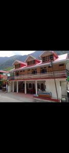 a large building with a bench in front of it at Hotel Ganga view & restaurant in Gangnāni