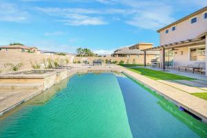a swimming pool in the backyard of a house at Beautiful 5 BR house Huge Pool SPA BBQ in Indio in Indio