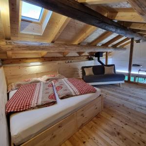 a bedroom with a bed in a wooden room at Bed&Breakfast La Sctalèta in Mesocco