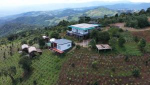an aerial view of a house on top of a hill at ASA Private Homestay - บ้านนายพราน แนววินเทจ in Ban Huai Khai