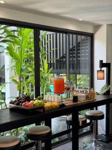 a table with a tray of fruit on it at POR Singharat in Chiang Mai